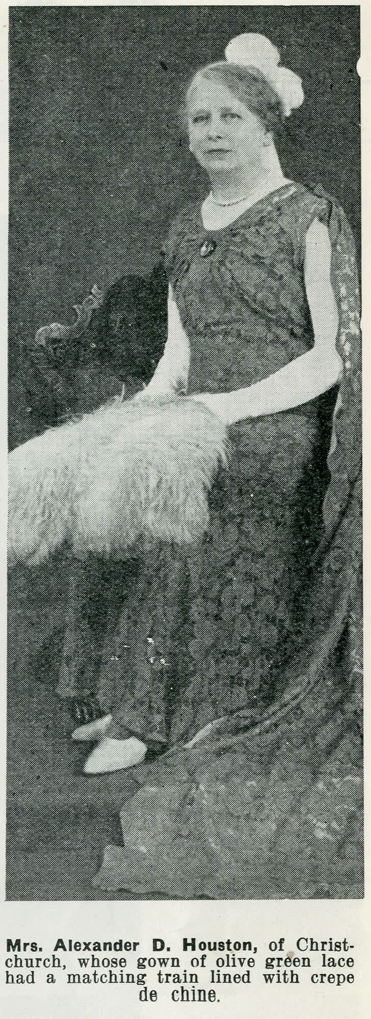 Mrs. Alexander D. Houston, of Christchurch, whose gown of olive green lace had a matching train lined with crepe de chine, 1937