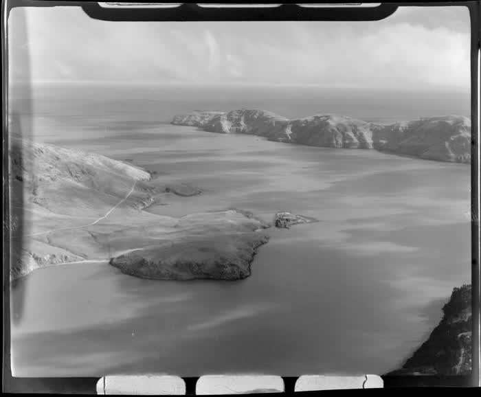 View to the Lyttelton Harbour entrance and Godley Head with Purua Bay and Banks Peninsula in foreground, Christchurch City, Canterbury Region, 1947