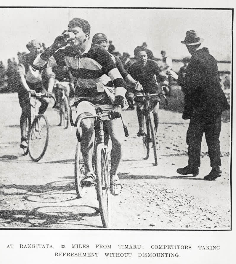 At Rangitata, 33 miles from Timaru: competitors taking refreshment without dismounting, 1923
