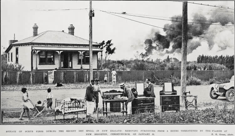 Menace of scrub fires during the recent dry spell in New Zealand: removing furniture from a house threatened by the flames at New Brighton, Christchurch, on January 12, 1924