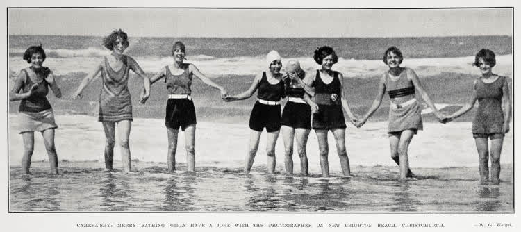 Camera shy; merry bathing girls have a joke with the photographer on New Brighton Beach, Christchurch, 1929
