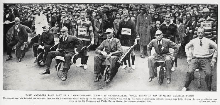 Bank managers take part in a 'wheelbarrow derby' in Christchurch: novel event in aid of Queen Carnival funds, 1935