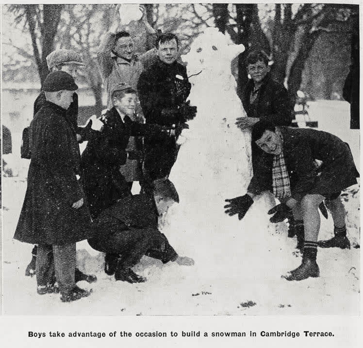 Boys take advantage of the occasion to build a snowman in Cambridge Terrace, 1936