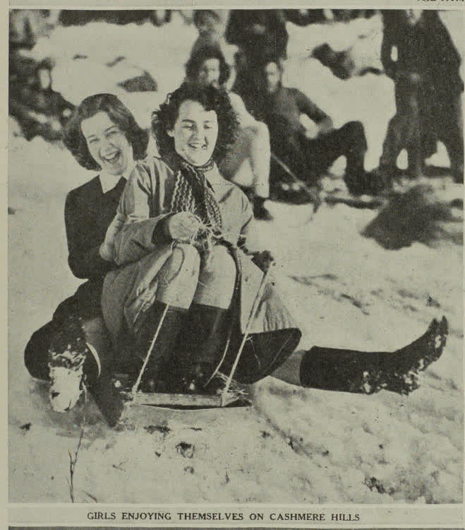 Girls enjoying themselves on Christchurch's Cashmere Hills during the recent record snowfall, 1945