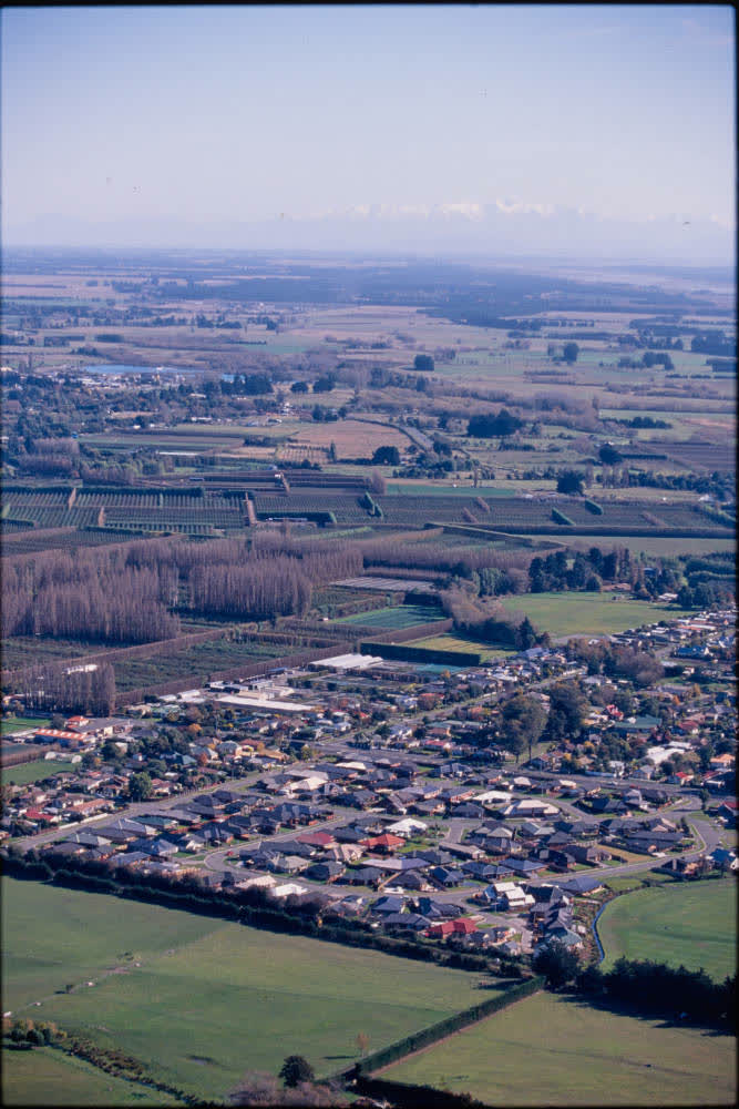 Aerial view of farmlands and suburbs, 1980