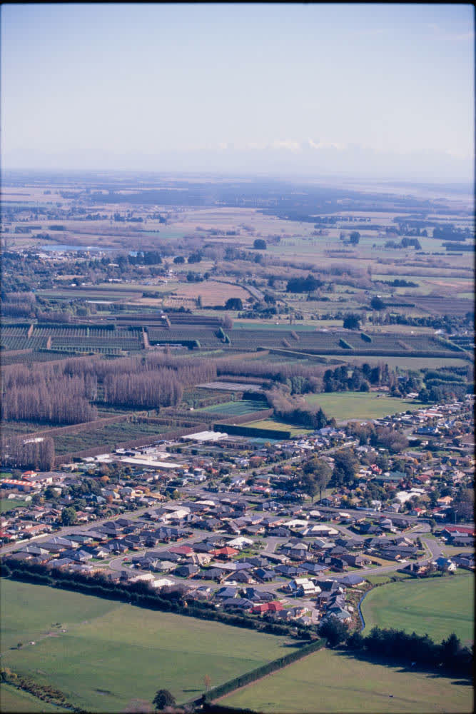 Aerial view of farmlands and suburbs, 1980