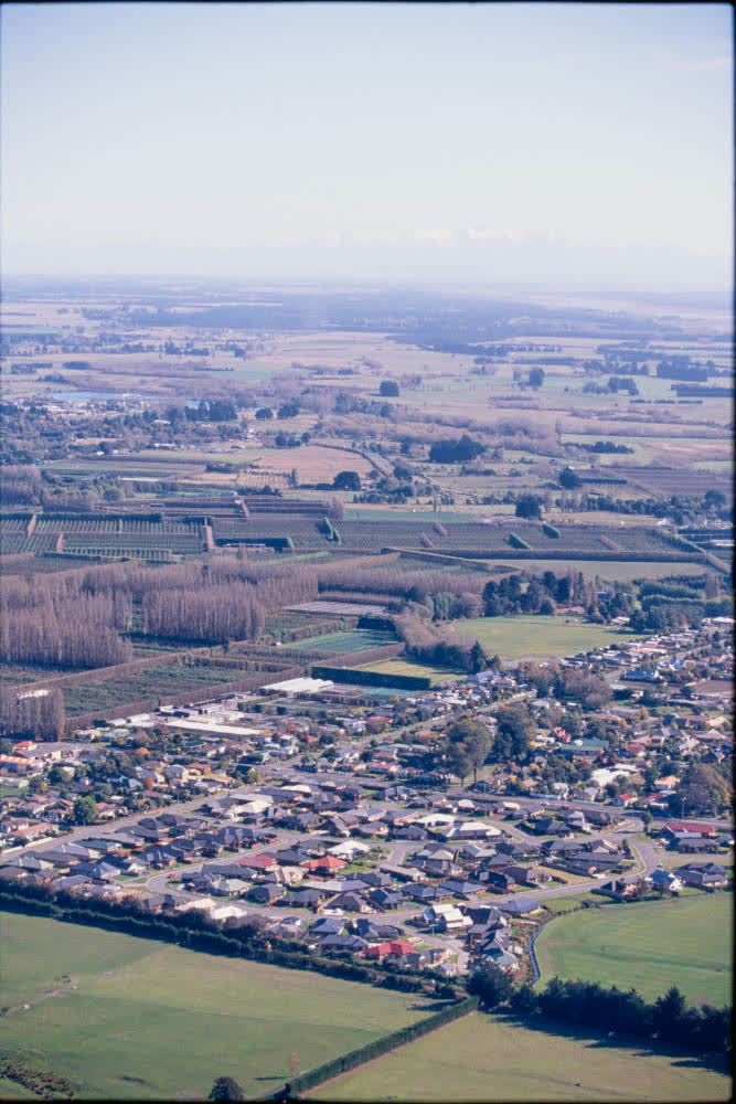 Aerial view of farmlands and suburbs, 1980