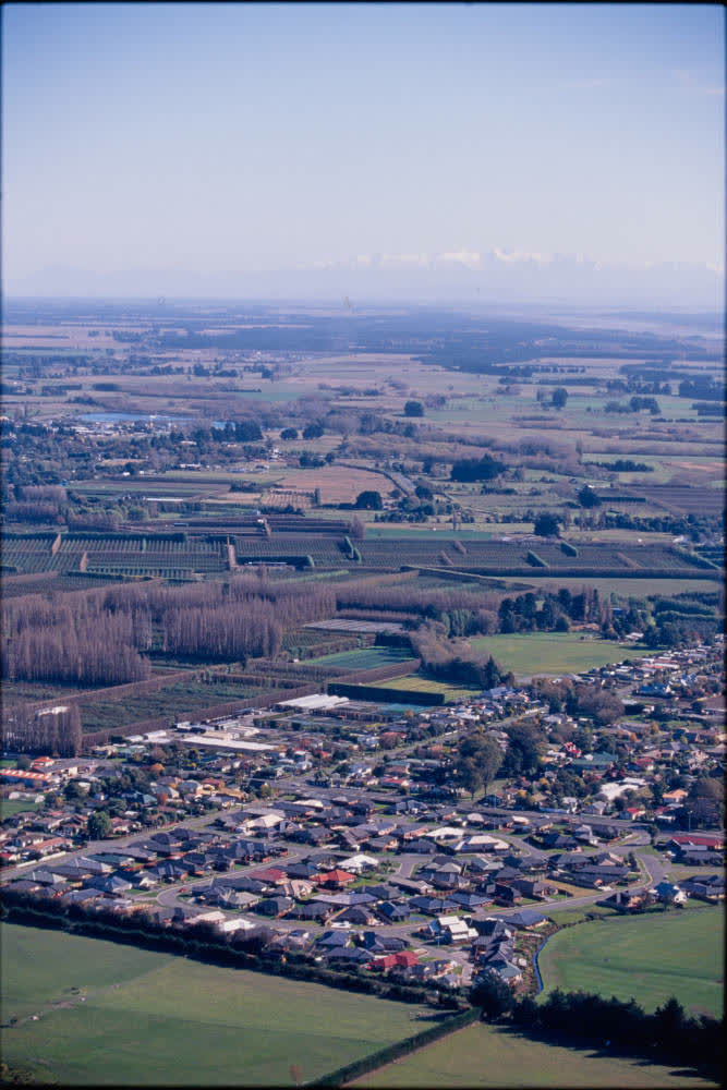 Aerial view of farmlands and suburbs, 1980