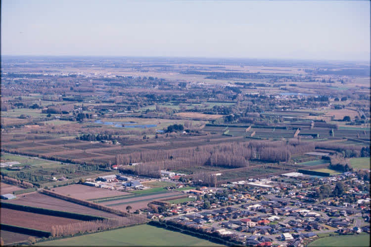 Aerial view of farmlands and suburbs, 1980