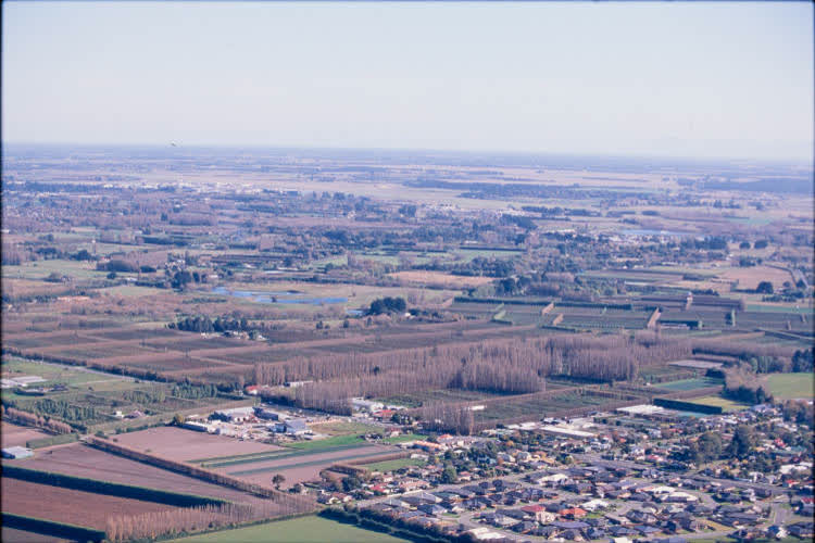 Aerial view of farmlands and suburbs, 1980