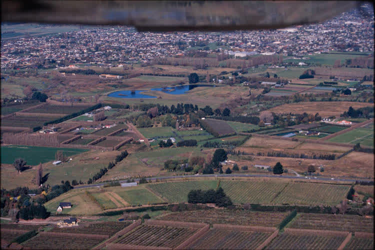 Aerial view of farmlands and suburbs, 1980