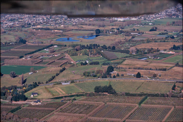 Aerial view of farmlands and suburbs, 1980