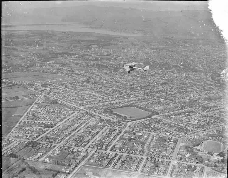 Gipsy Moth aircraft flying over Christchurch from the air, 1930, 1930