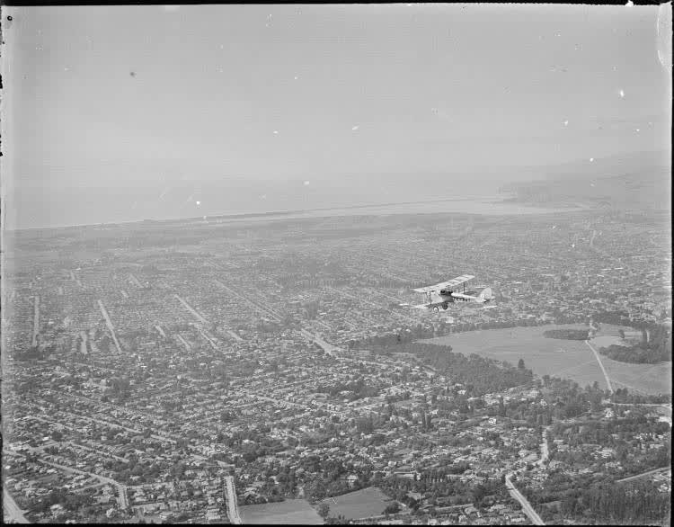 Gipsy Moth aircraft flying over Christchurch from the air, 1930, 1930