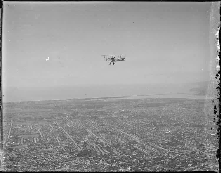 Gipsy Moth aircraft flying over Christchurch from the air, 1920