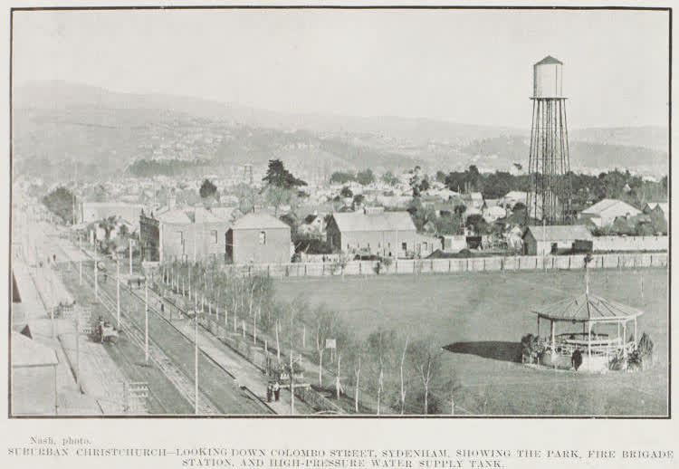 Christchurch - looking down Colombo Street, Sydenham, showing the park, fire brigade station, and high-pressure water supply tank, 1912