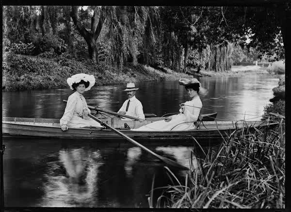 Two women and a man in a rowboat and canoe on the Avon River, 1900
