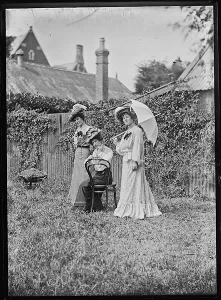 Four women in a garden, 1900