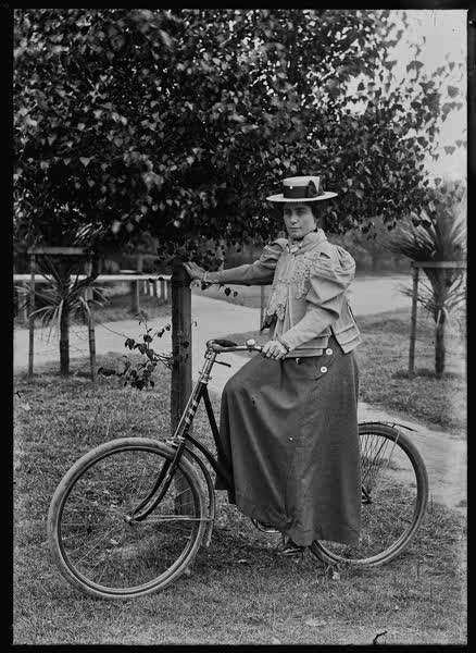 Woman on a bicycle in the Botanic Gardens, 1900
