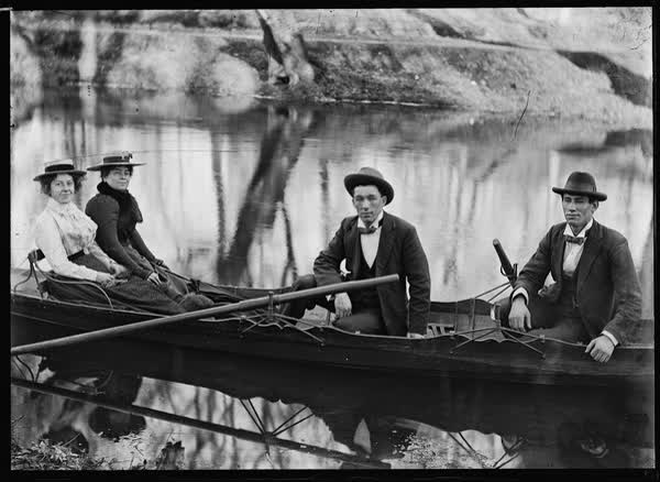Two men and two women in a large rowboat on the Avon River, 1900