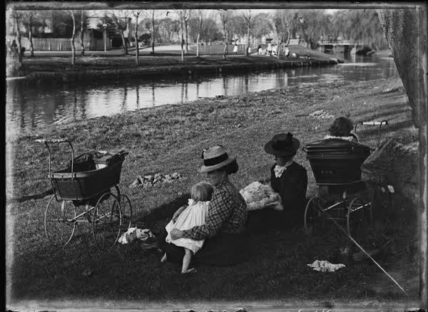 Two women with prams and young children, 1900