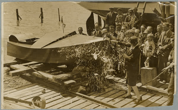 Mrs Elizabeth McCombs christening a motorboat, 1928