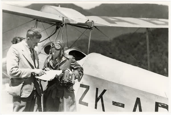 William McKaskell with biplane and plate camera, 1932