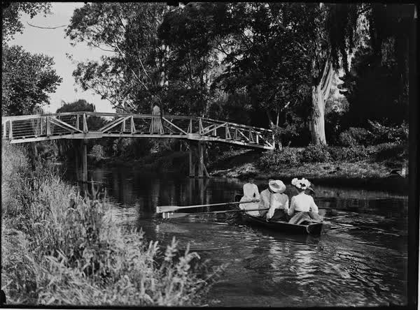 Three women and one man in a rowboat on the Avon River, 1900