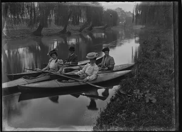 Three women and one man in canoes on the Avon River, 1900