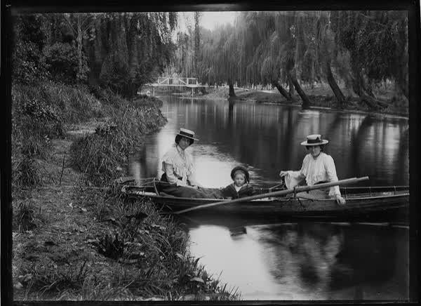 Two women and child in rowboat on the Avon River, 1900