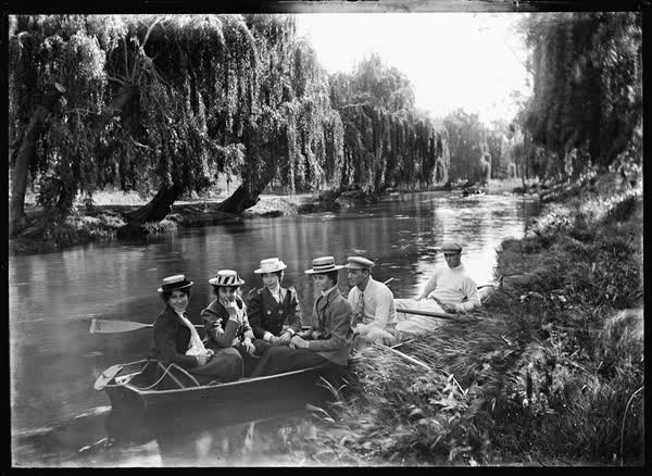 Four women and two men in a rowboat on the Avon River, 1900