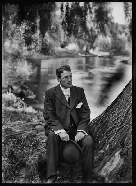 Man seated on willow trunk, 1900