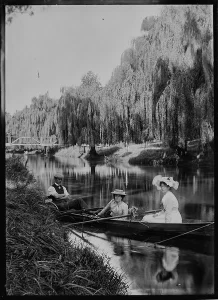 Two women and a man in a rowboat on the Avon River, 1900