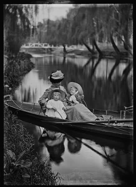 Woman and two children in a rowboat on the Avon River, 1900