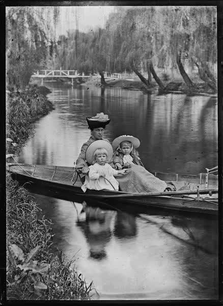 Woman and two children in a rowboat on the Avon River, 1900