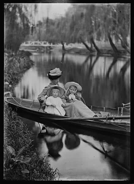 Woman and two children in a rowboat on the Avon River, 1900
