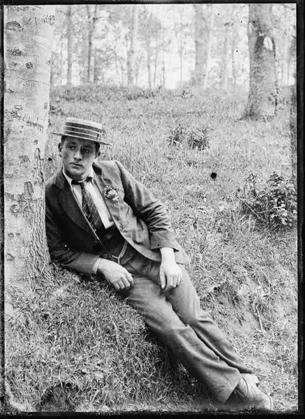 Man reclining in Hagley Park, 1900