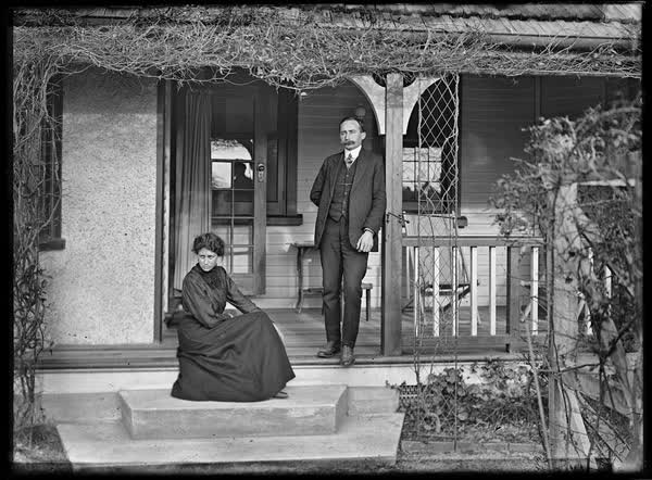 Man and woman on the steps of a house, 1900