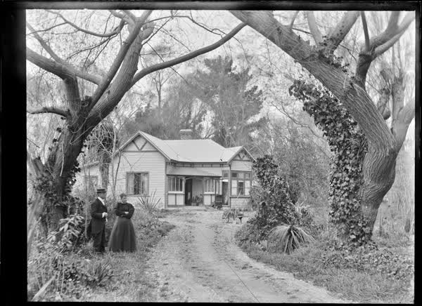View down a driveway to a weatherboard house, 1900