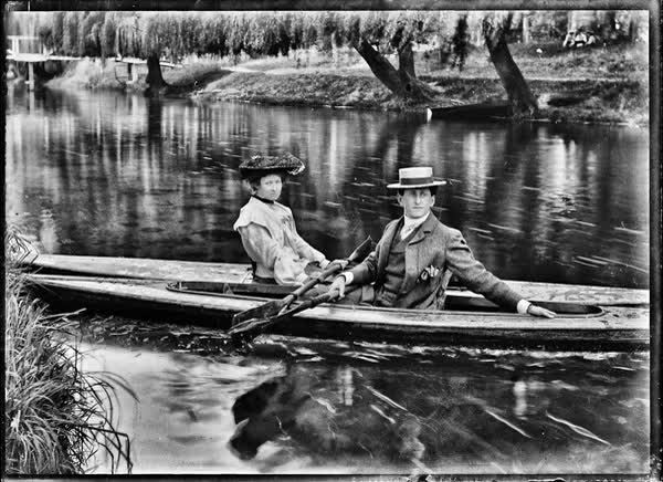 Man and woman in canoes on the Avon River, 1900