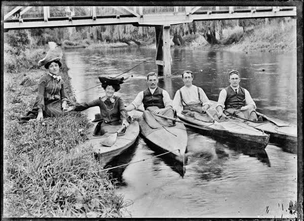 Three men and a woman in canoes on the Avon River, 1900