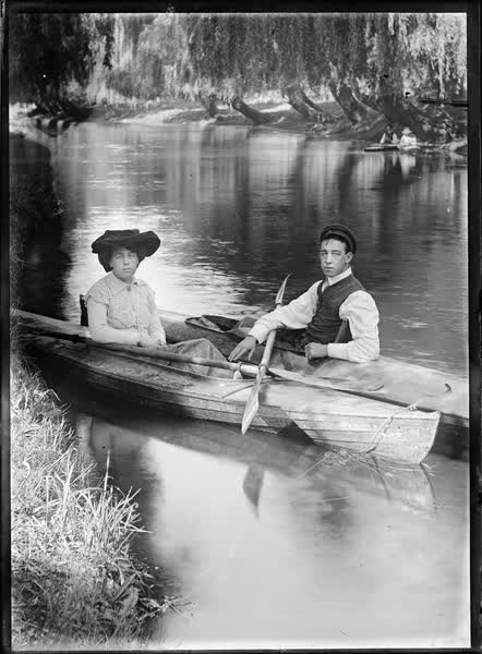 Man and woman in canoes on the Avon River, 1900