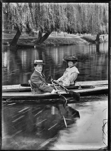 Man and woman in canoes on the Avon River, 1900