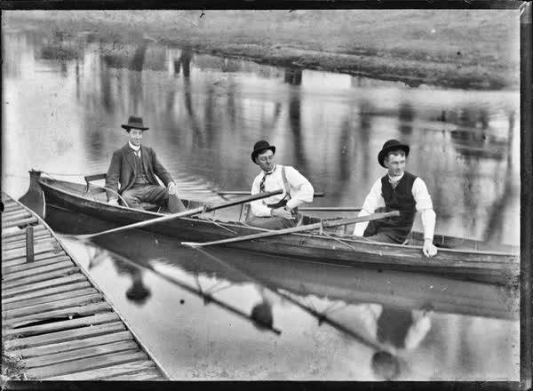 Three men in a double rowboat on the Avon River, 1900