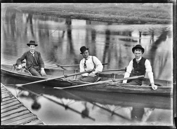 Three men in a double rowboat on the Avon River, 1900
