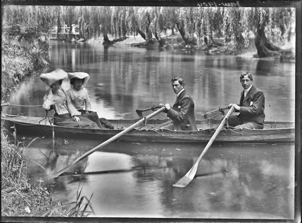 Two men and two women in a double rowboat on the Avon River, 1904