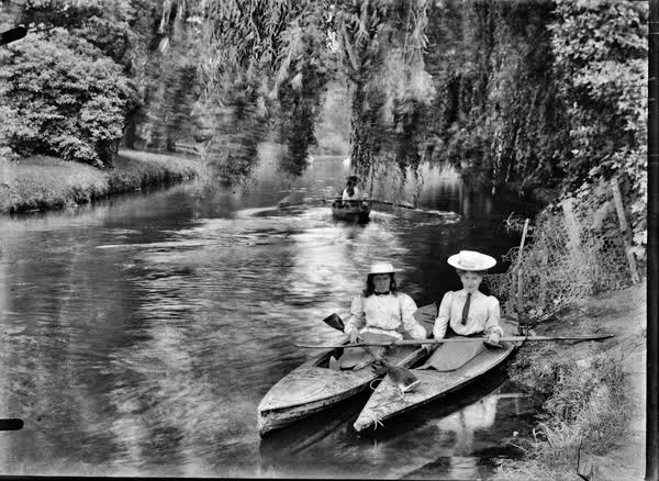 Woman and a girl in canoes on the Avon River, 1900