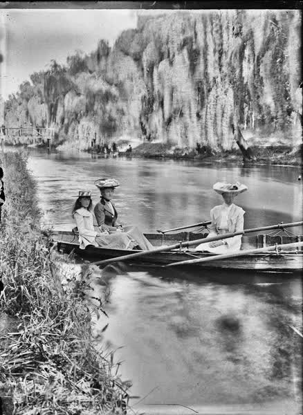 Two women and a girl in a double rowboat on the Avon River, 1900