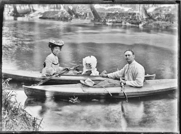 Man, woman and a child in canoes on the Avon River, 1900