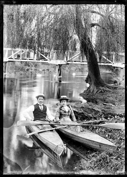 Man and woman in canoes on the Avon River, 1900